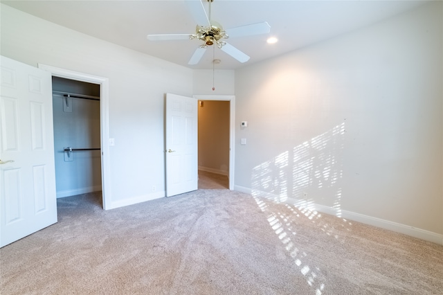 unfurnished bedroom with ceiling fan, a closet, carpet flooring, and baseboards