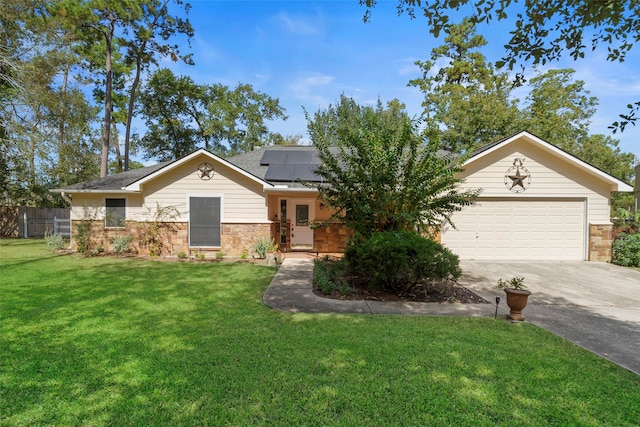 ranch-style home with a front yard, a garage, and solar panels