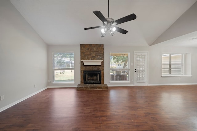 unfurnished living room with dark wood-type flooring, ceiling fan, vaulted ceiling, and a fireplace