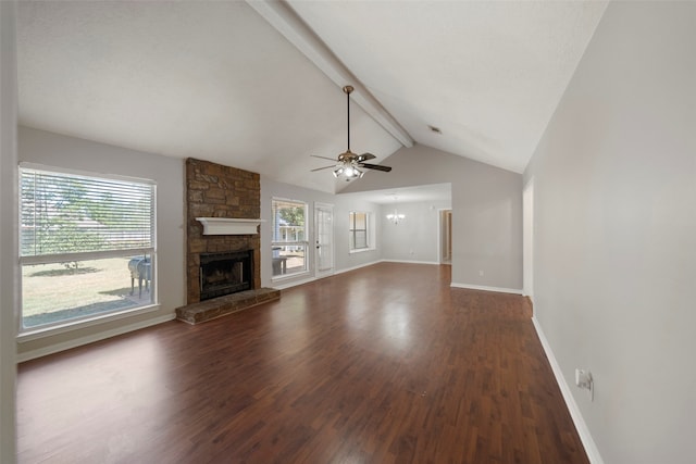 unfurnished living room featuring lofted ceiling with beams, a wealth of natural light, and dark hardwood / wood-style flooring