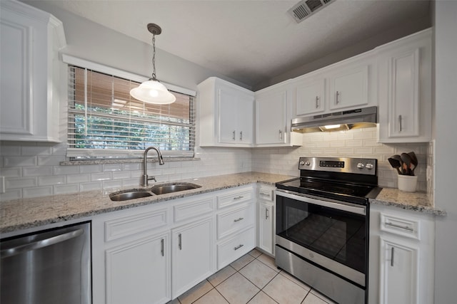 kitchen with decorative backsplash, stainless steel appliances, sink, light tile patterned floors, and white cabinetry