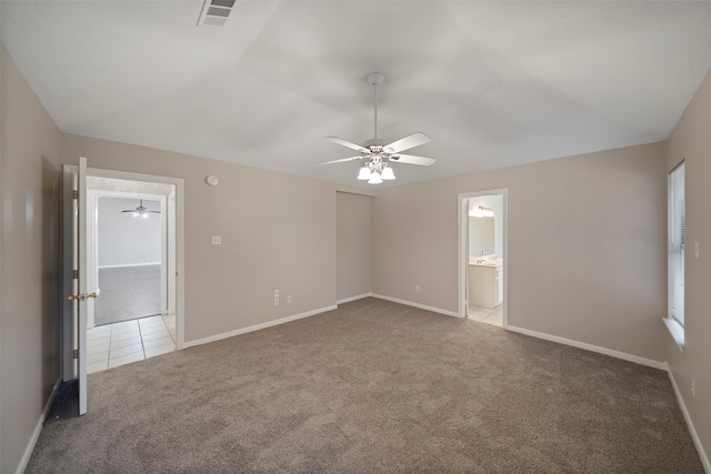 carpeted empty room featuring ceiling fan and vaulted ceiling