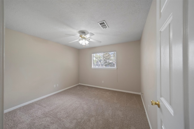 carpeted empty room featuring a textured ceiling and ceiling fan