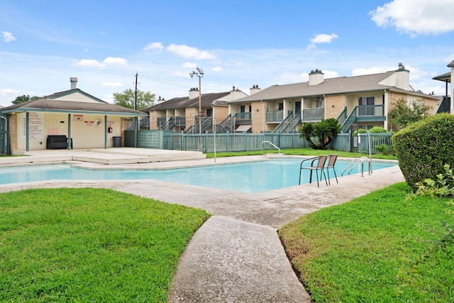 view of pool with a yard and a patio