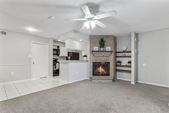 unfurnished living room featuring a textured ceiling, ceiling fan, a fireplace, and light carpet