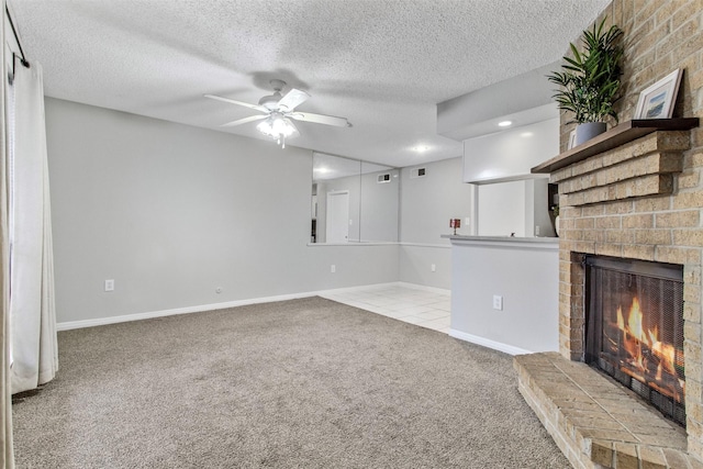 unfurnished living room with light carpet, a textured ceiling, a brick fireplace, and ceiling fan