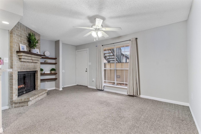 unfurnished living room with a fireplace, a textured ceiling, carpet floors, and ceiling fan