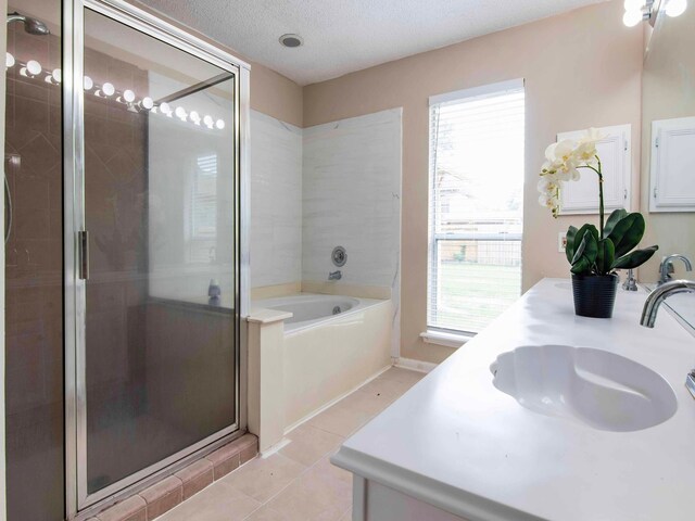 bathroom featuring vanity, a healthy amount of sunlight, independent shower and bath, and a textured ceiling