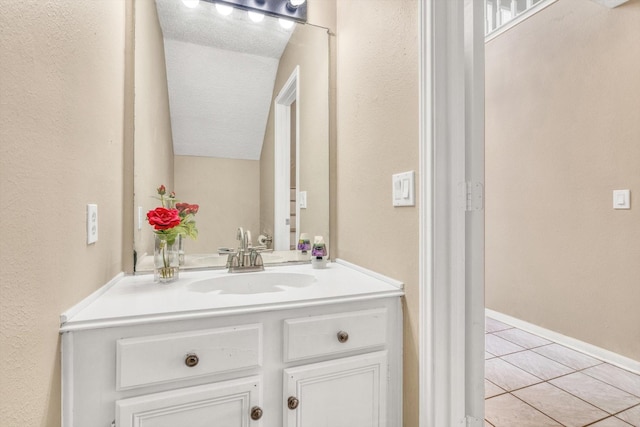 5635 Sage Manor Dr, Houston, TX 77084 - bathroom featuring tile patterned flooring, a textured wall, vanity, and baseboards
