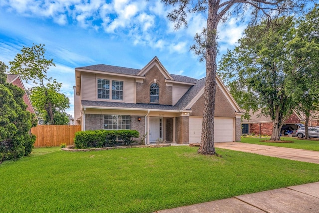 5635 Sage Manor Dr, Houston, TX 77084 - traditional home featuring brick siding, fence, driveway, a front lawn, and an attached garage