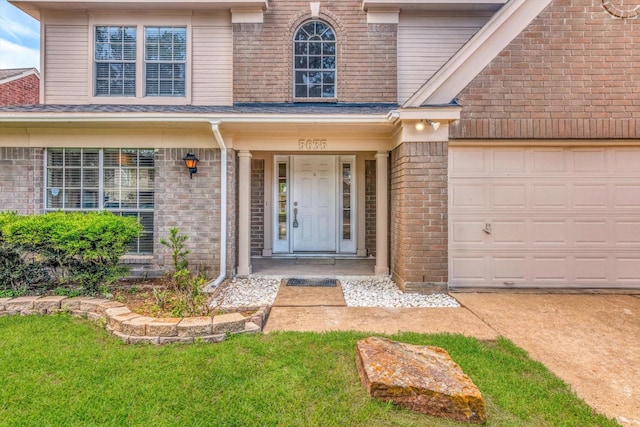 5635 Sage Manor Dr, Houston, TX 77084 - view of exterior entry with covered porch, brick siding, and an attached garage