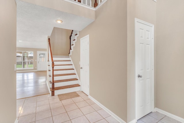 5635 Sage Manor Dr, Houston, TX 77084 - staircase featuring baseboards and tile patterned flooring