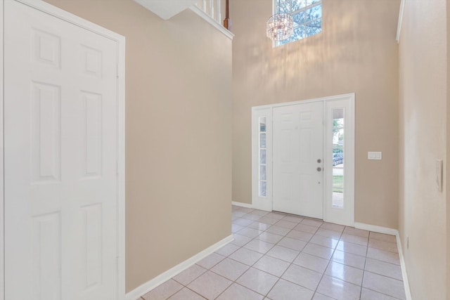 5635 Sage Manor Dr, Houston, TX 77084 - entryway with light tile patterned floors, baseboards, and plenty of natural light