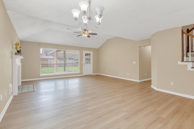 5635 Sage Manor Dr, Houston, TX 77084 - unfurnished living room featuring baseboards, light wood-type flooring, ceiling fan with notable chandelier, and stairs