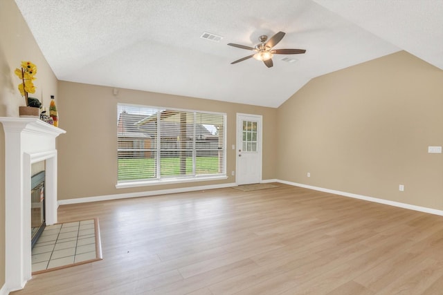 5635 Sage Manor Dr, Houston, TX 77084 - unfurnished living room with visible vents, vaulted ceiling, ceiling fan, baseboards, and light wood-type flooring