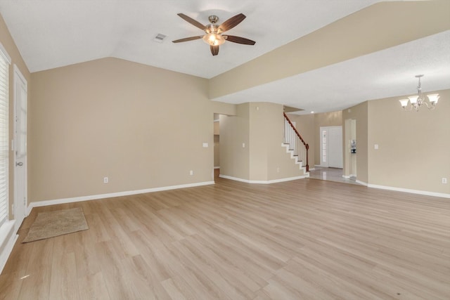 5635 Sage Manor Dr, Houston, TX 77084 - unfurnished living room featuring stairway, visible vents, light wood-type flooring, vaulted ceiling, and ceiling fan with notable chandelier