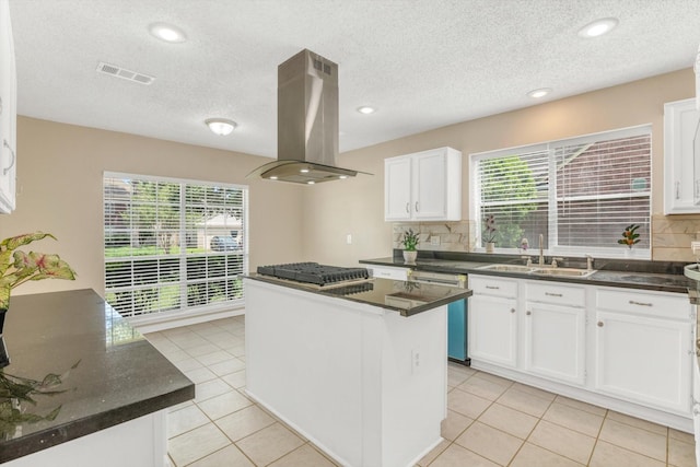 5635 Sage Manor Dr, Houston, TX 77084 - kitchen featuring decorative backsplash, a sink, island range hood, a center island, and dishwasher