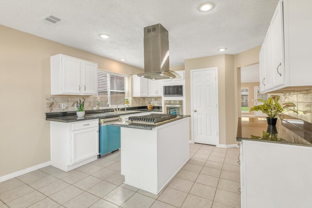5635 Sage Manor Dr, Houston, TX 77084 - kitchen featuring dark countertops, stainless steel appliances, island range hood, and decorative backsplash