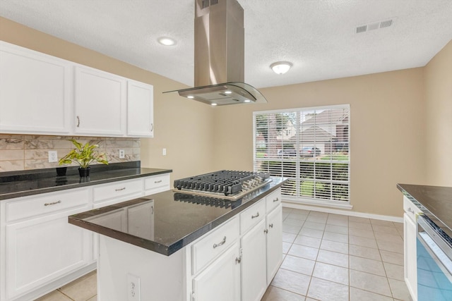 5635 Sage Manor Dr, Houston, TX 77084 - kitchen with a textured ceiling, decorative backsplash, appliances with stainless steel finishes, visible vents, and island exhaust hood