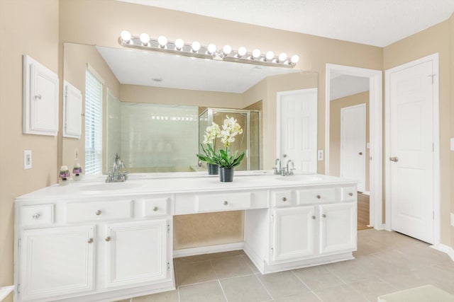 5635 Sage Manor Dr, Houston, TX 77084 - bathroom with a stall shower, double vanity, a sink, and tile patterned floors