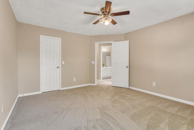 5635 Sage Manor Dr, Houston, TX 77084 - unfurnished bedroom with a textured ceiling, a ceiling fan, carpet flooring, and baseboards