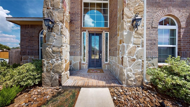 entrance to property with stone siding and brick siding