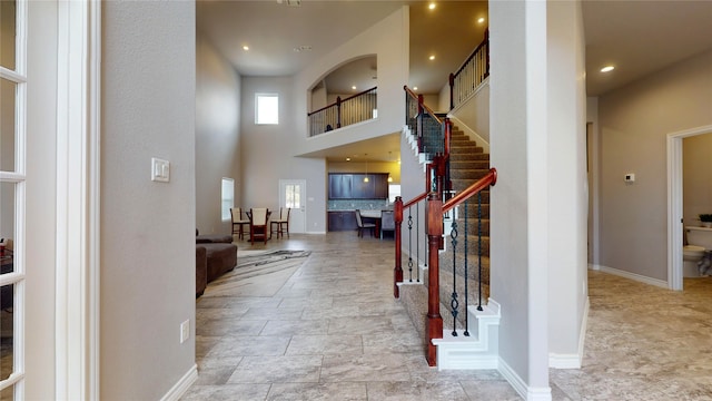 tiled foyer entrance with a towering ceiling