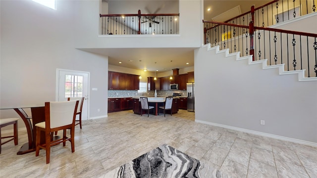 interior space featuring a high ceiling and light tile patterned floors