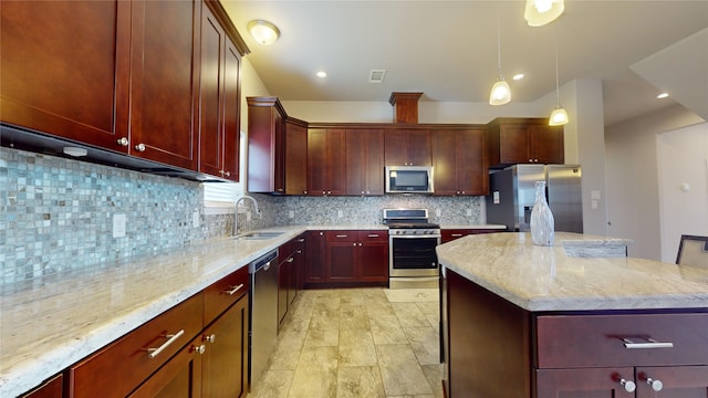 kitchen featuring light stone countertops, tasteful backsplash, a center island, stainless steel appliances, and sink