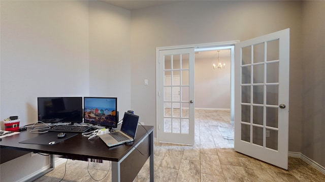 tiled office space with french doors and a notable chandelier