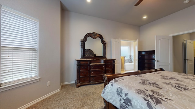 bedroom with ensuite bath, ceiling fan, and carpet