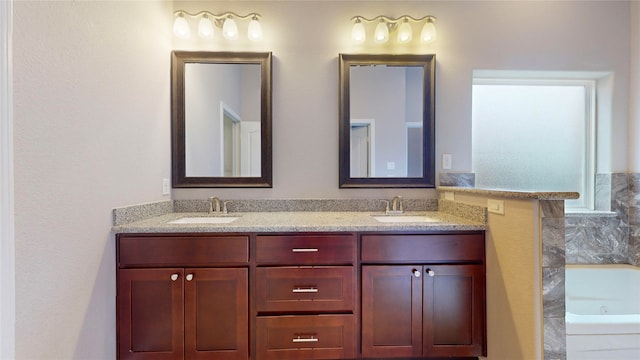 bathroom with a tub to relax in and vanity