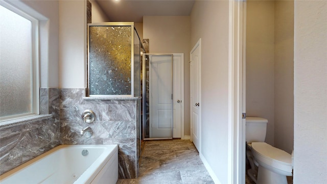 bathroom featuring tile patterned flooring, toilet, and separate shower and tub