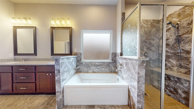 bathroom featuring vanity and separate shower and tub