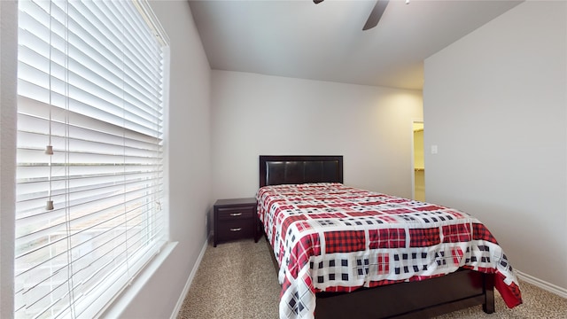 bedroom featuring multiple windows, ceiling fan, and carpet