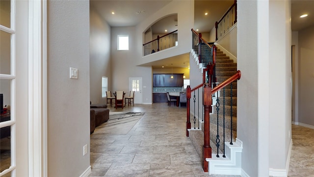 tiled entryway with a high ceiling