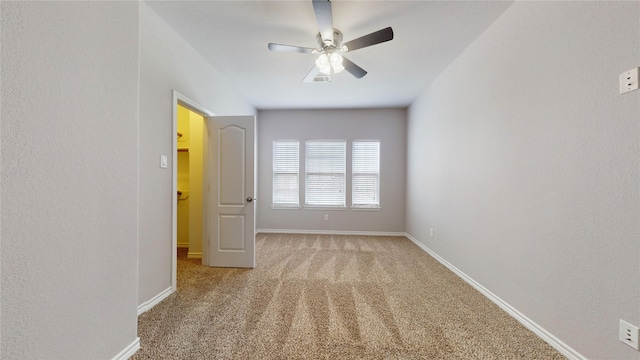 carpeted spare room featuring ceiling fan