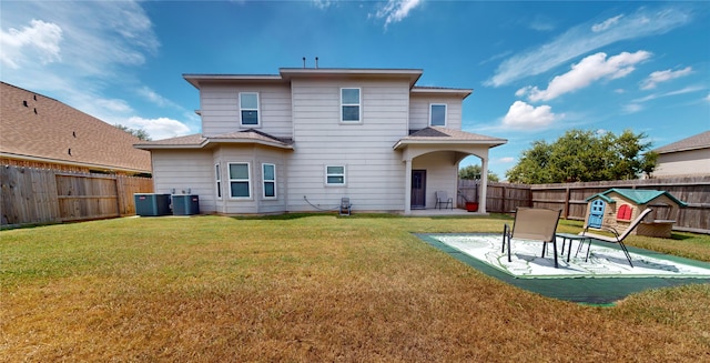 rear view of house featuring central AC, a yard, and a patio