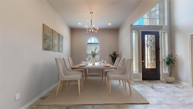 dining room with light tile patterned floors and a chandelier