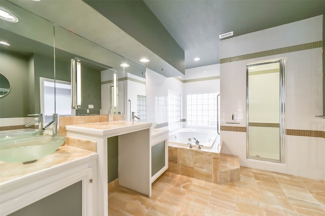 bathroom with tile patterned floors, shower with separate bathtub, and vanity