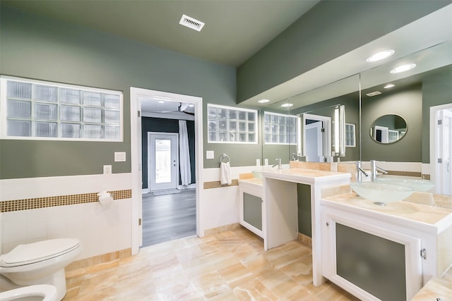 bathroom featuring hardwood / wood-style floors, toilet, a bidet, and vanity