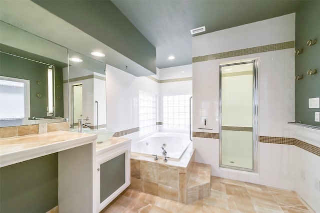 bathroom featuring vanity, independent shower and bath, and tile patterned floors