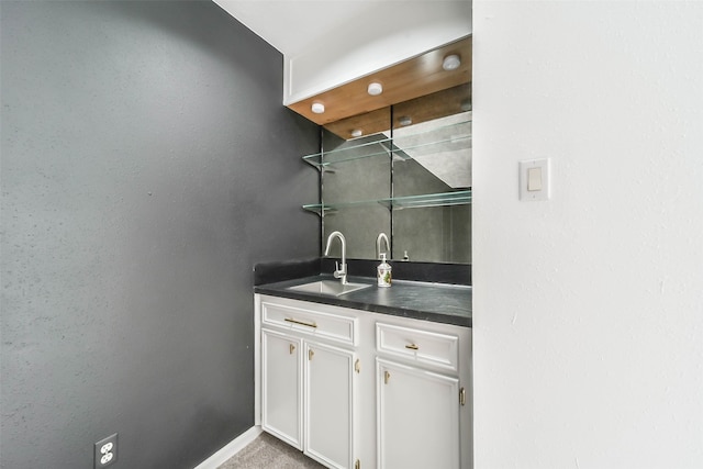 bar featuring sink and white cabinets