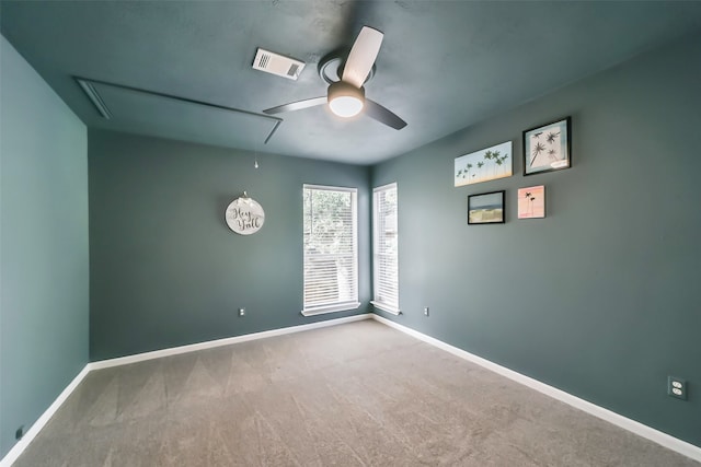 carpeted spare room with ceiling fan