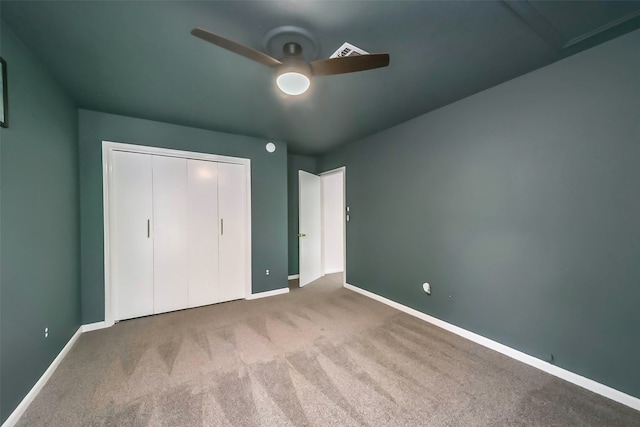 unfurnished bedroom with ceiling fan, a closet, and carpet floors