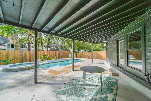 view of swimming pool featuring an in ground hot tub and a patio area