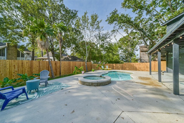 view of swimming pool featuring a patio area and an in ground hot tub