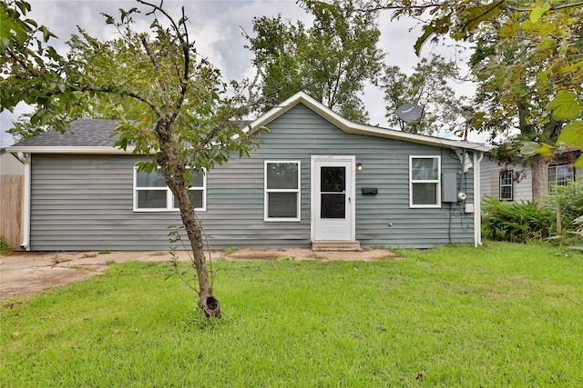 rear view of property with a lawn