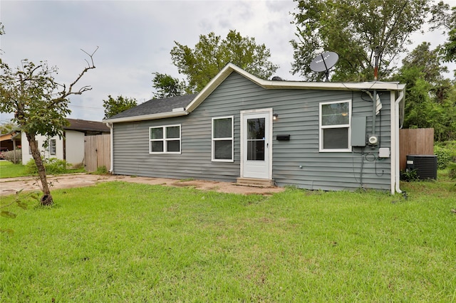 exterior space featuring a front lawn and central AC