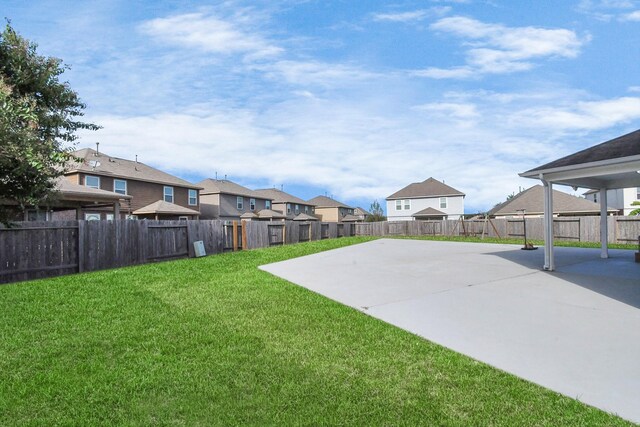 18306 Fresh Air Ct, Houston, TX 77084 - view of yard with a fenced backyard, a patio area, and a residential view